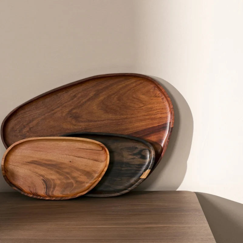Three leaf trays in different sizes leaning together, showing light and dark grain