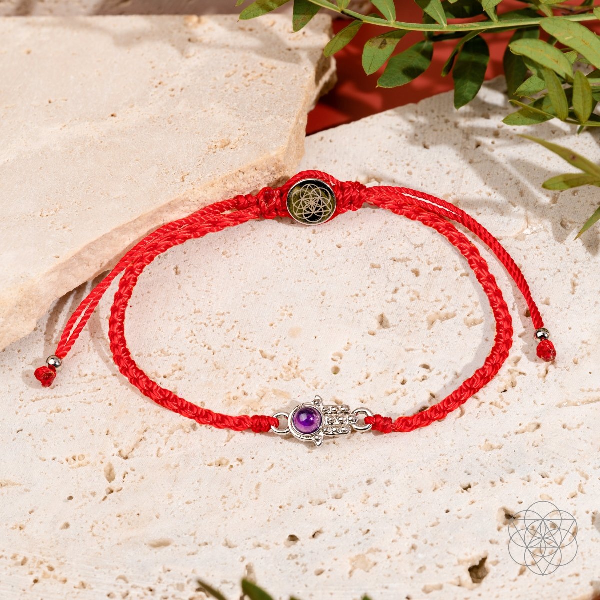 Four-strand red string bracelet with a silver-plated hamsa hand charm set with a purple Brazilian amethyst