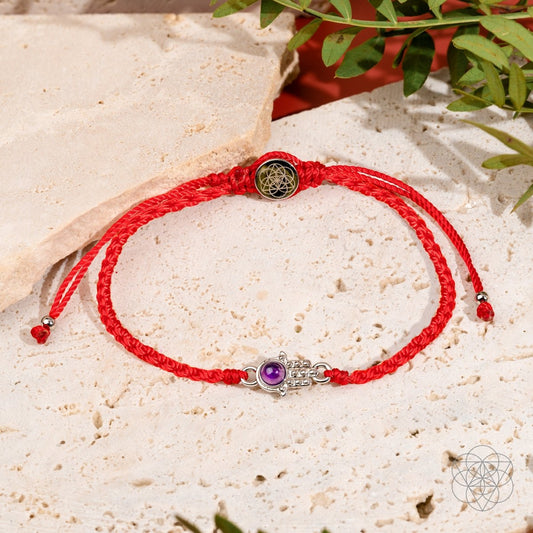 Four-strand red string bracelet with a silver-plated hamsa hand charm set with a purple Brazilian amethyst