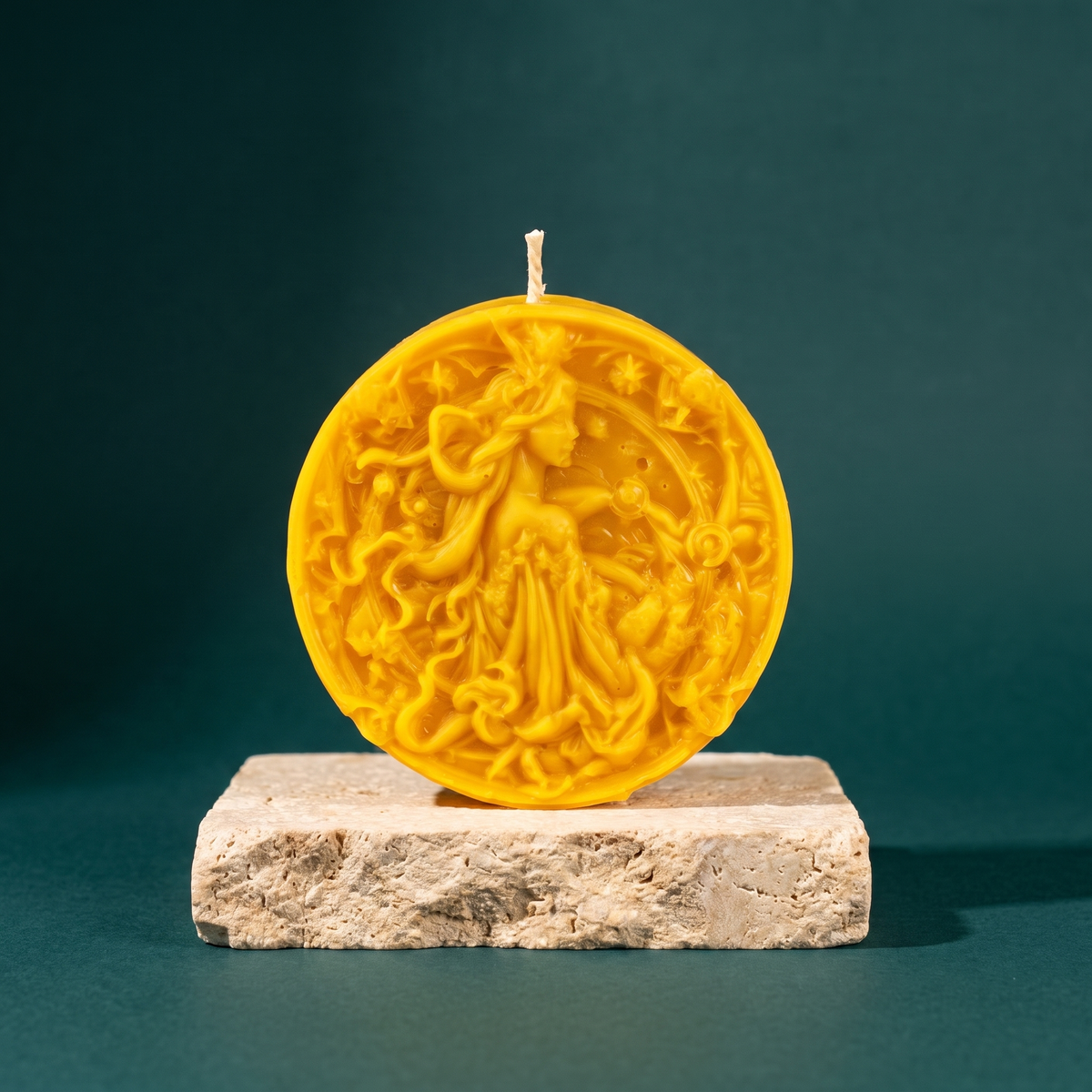Beeswax Libra Scales zodiac spell candle in yellow on a stone plinth against a green backdrop