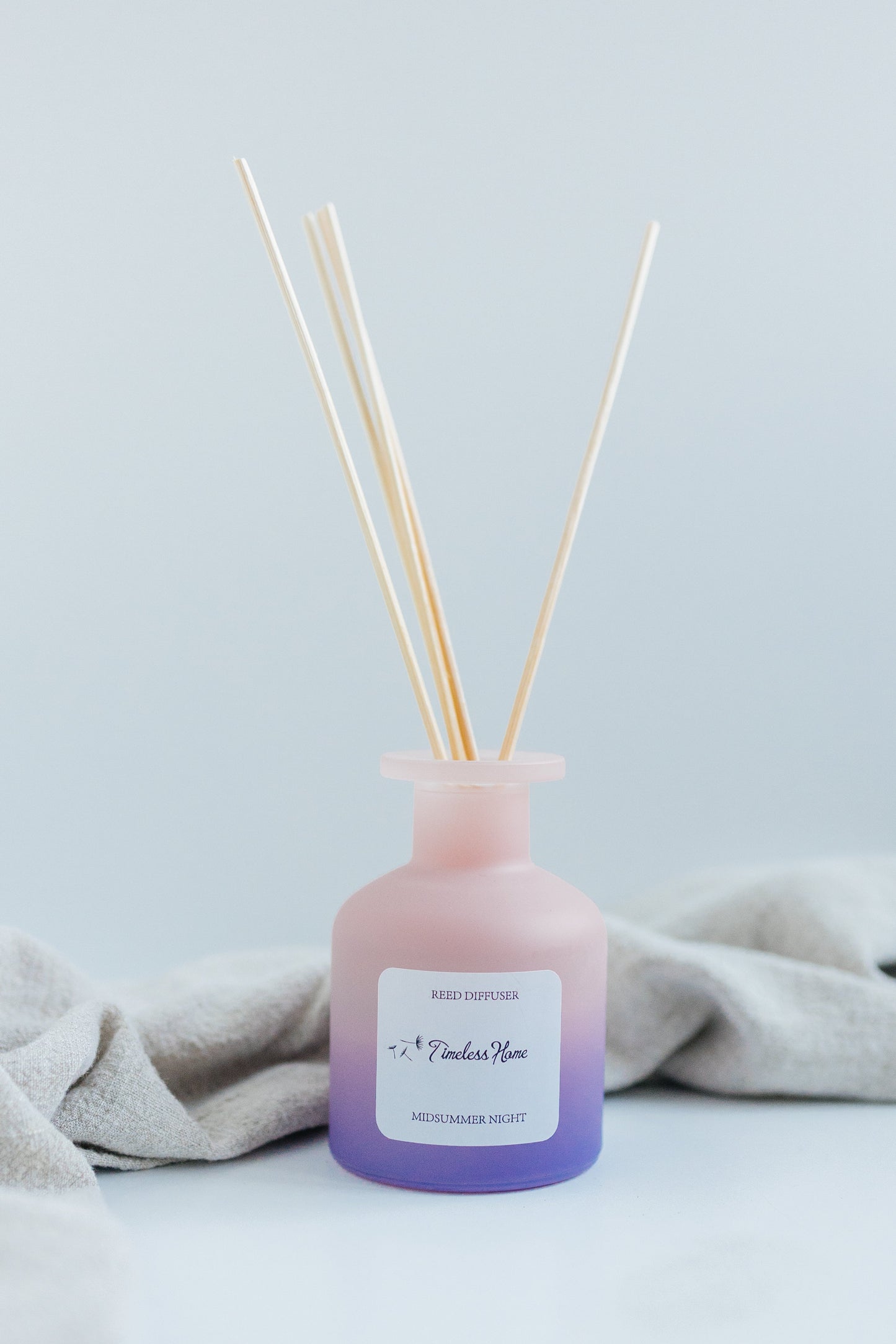 Midsummer Night reed diffuser in a frosted glass vessel with five natural reed sticks — view 4