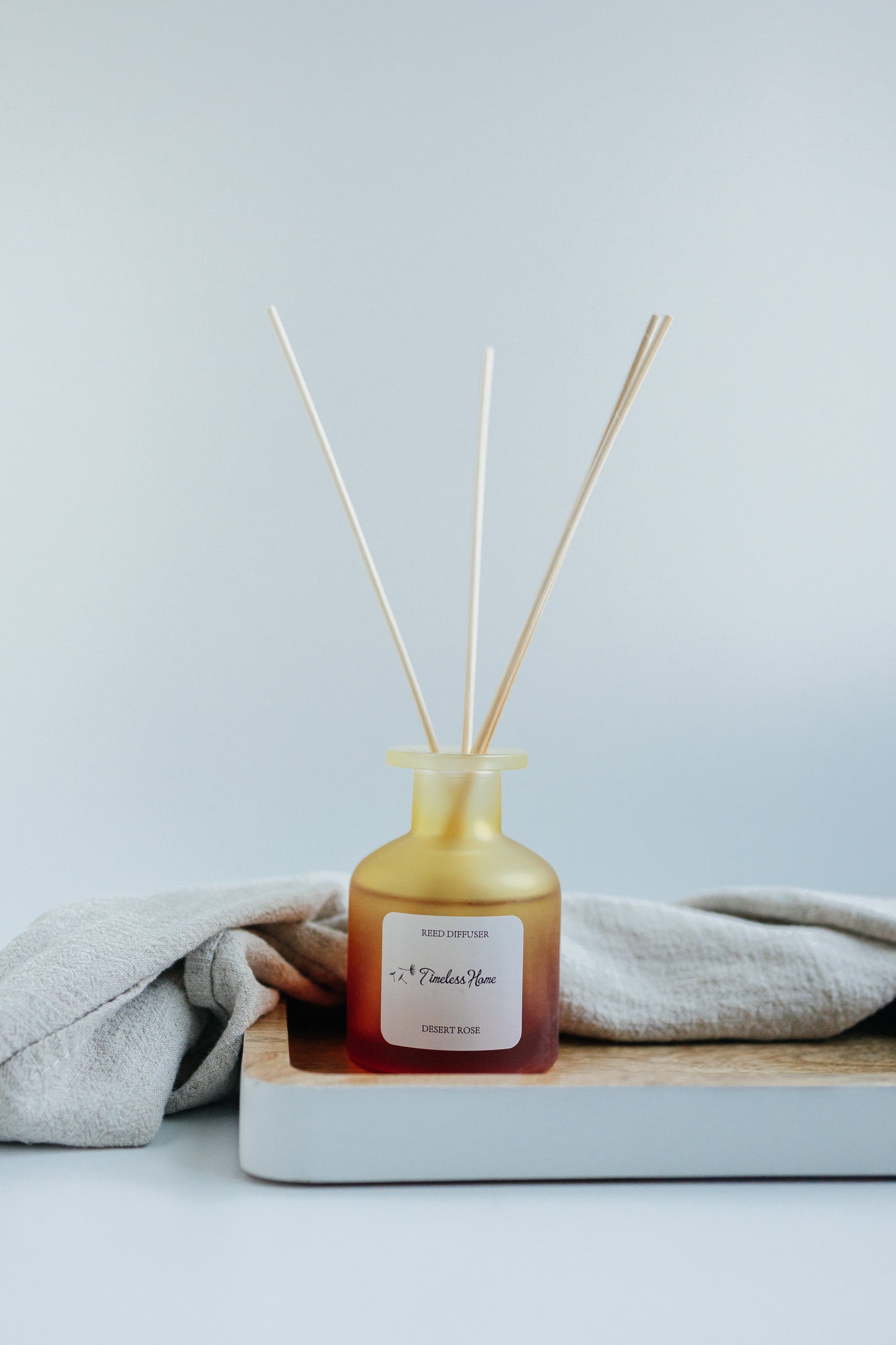 Desert Rose reed diffuser styled on a dark dressing table