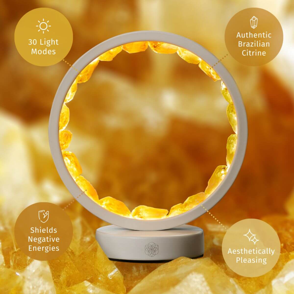 Infinite Abundance citrine halo lamp lined with raw citrine clusters, glowing on a desk