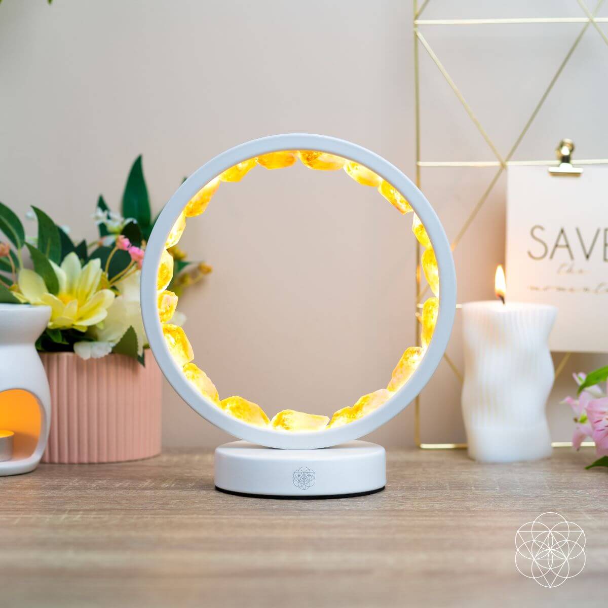 Infinite Abundance citrine halo lamp lined with raw citrine clusters, glowing on a desk (view 6)
