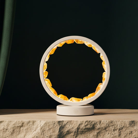 Citrine halo lamp glowing on a stone ledge against a dark green wall