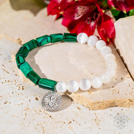 Bracelet with deep green malachite beads on one side and translucent selenite on the other, joined by a platinum-plated infinity charm