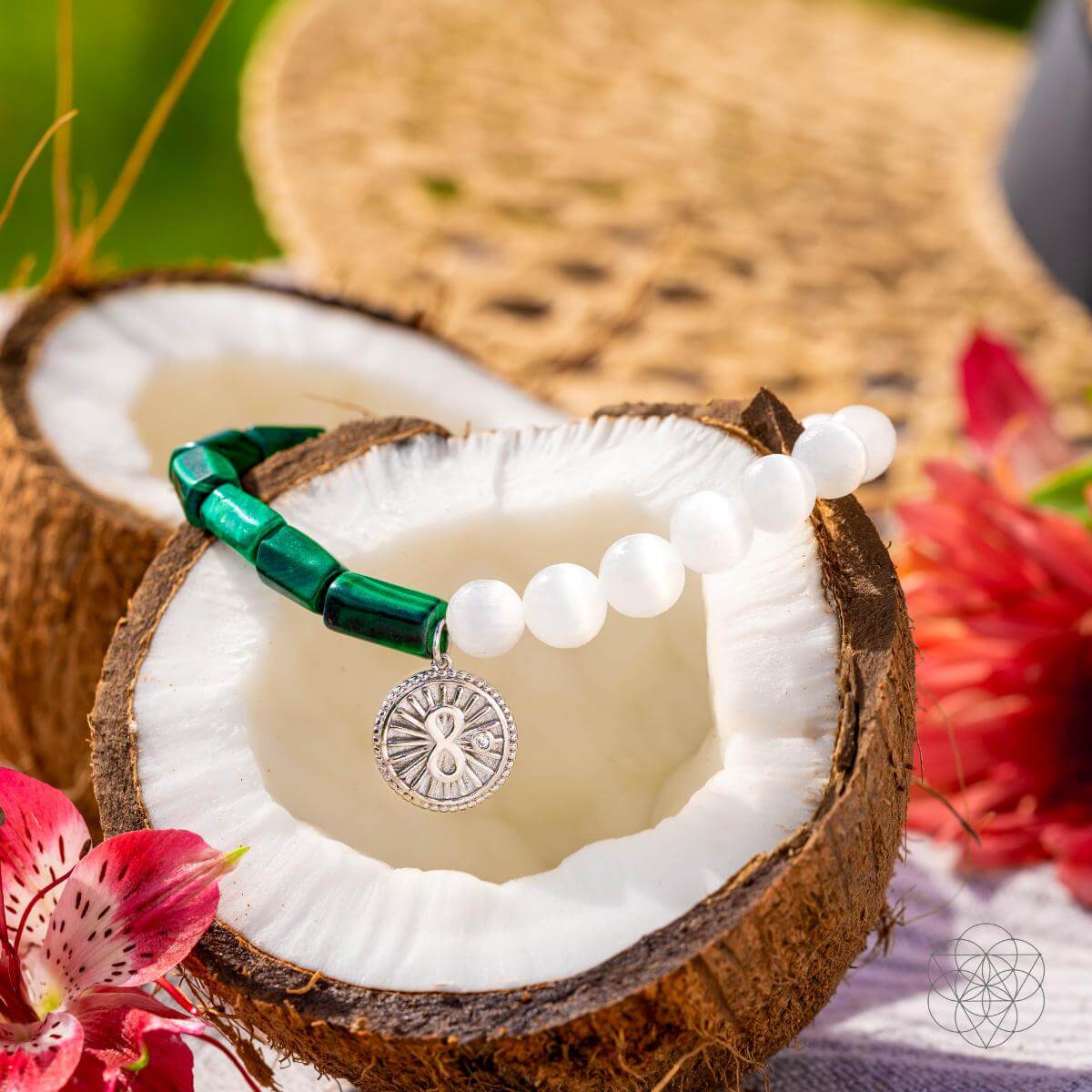 Bracelet with deep green malachite beads on one side and translucent selenite on the other, joined by a platinum-plated infinity charm — detail view 4