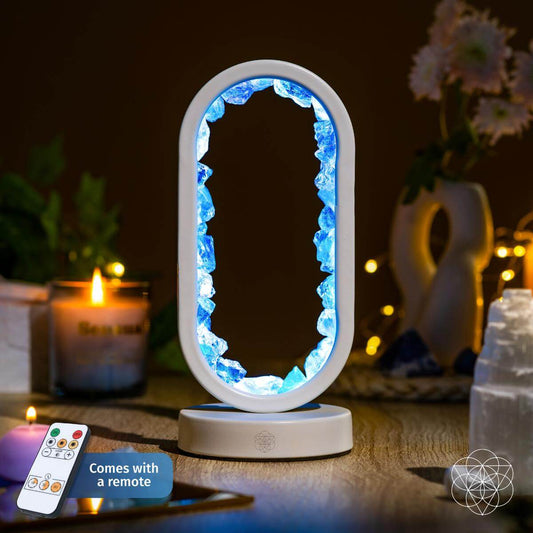 Aura-plated clear quartz lamp glowing in deep blue hues