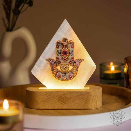 Selenite mood lamp topped with a Hamsa Hand talisman
