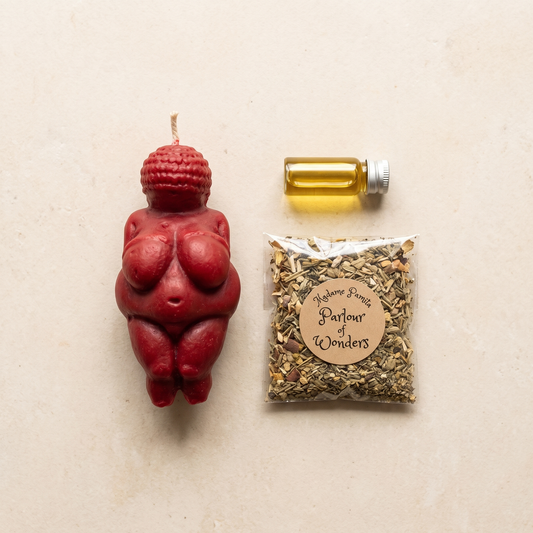 Goddess of Willendorf Candle Spell Kit laid out with the beeswax goddess candle, three herbs, spiritual oil and instructions
