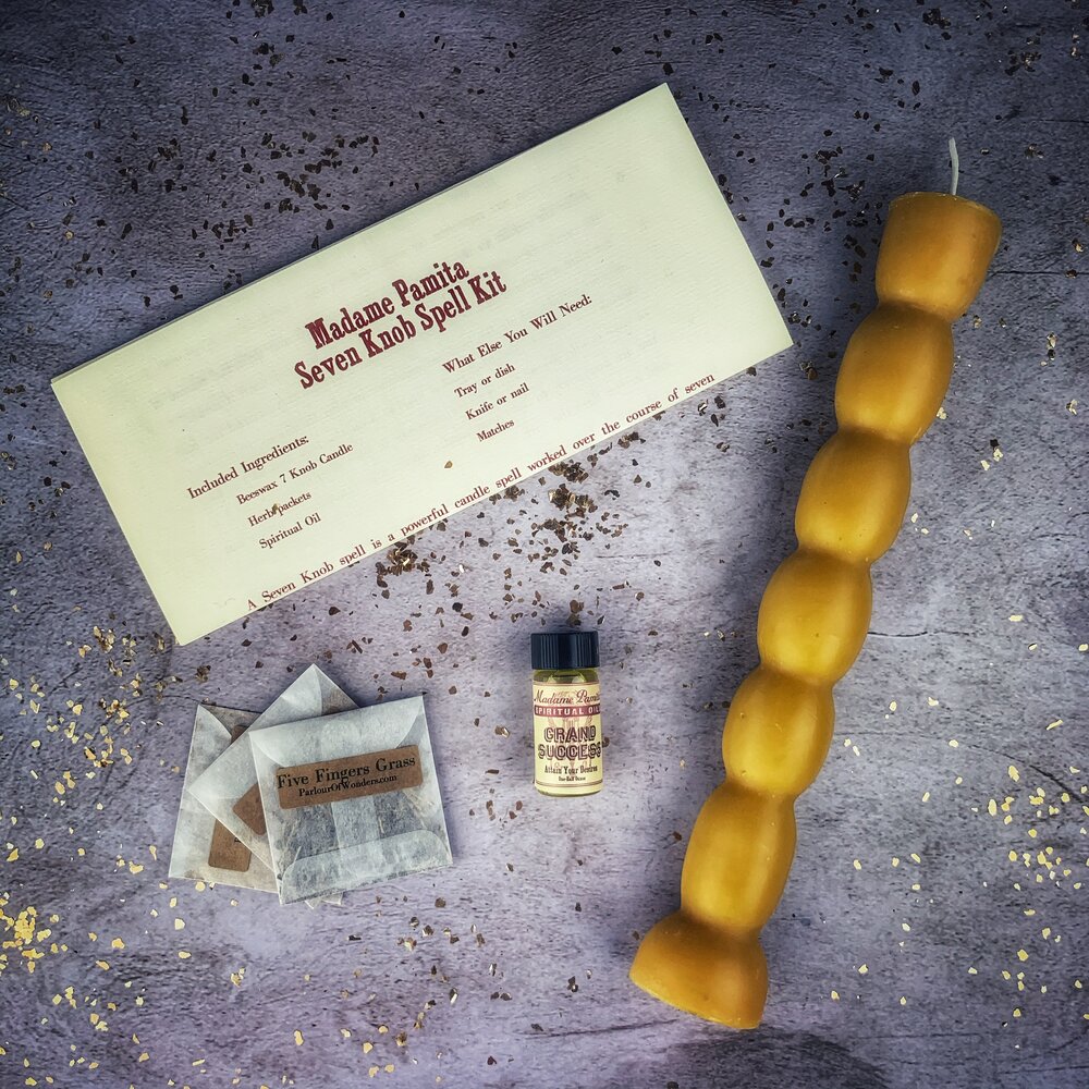 Close-up of the stacked knobs on a handmade beeswax seven knob spell candle.