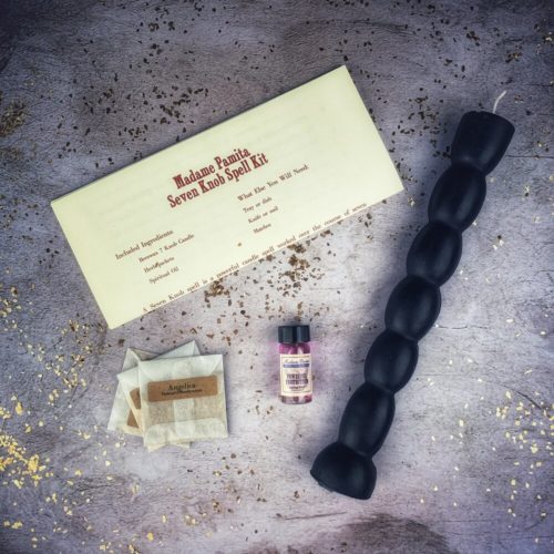 Seven knob beeswax spell candle from the Seven Knob Candle Spell Kit, standing upright.