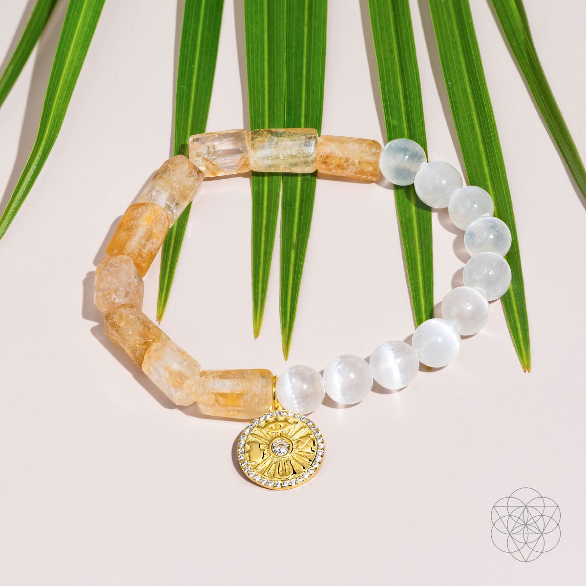 Citrine and selenite beaded bracelet with a gold-plated charm bearing the Eye of Horus, four-leaf clover, hamsa hand and horseshoe — view 6 of 8