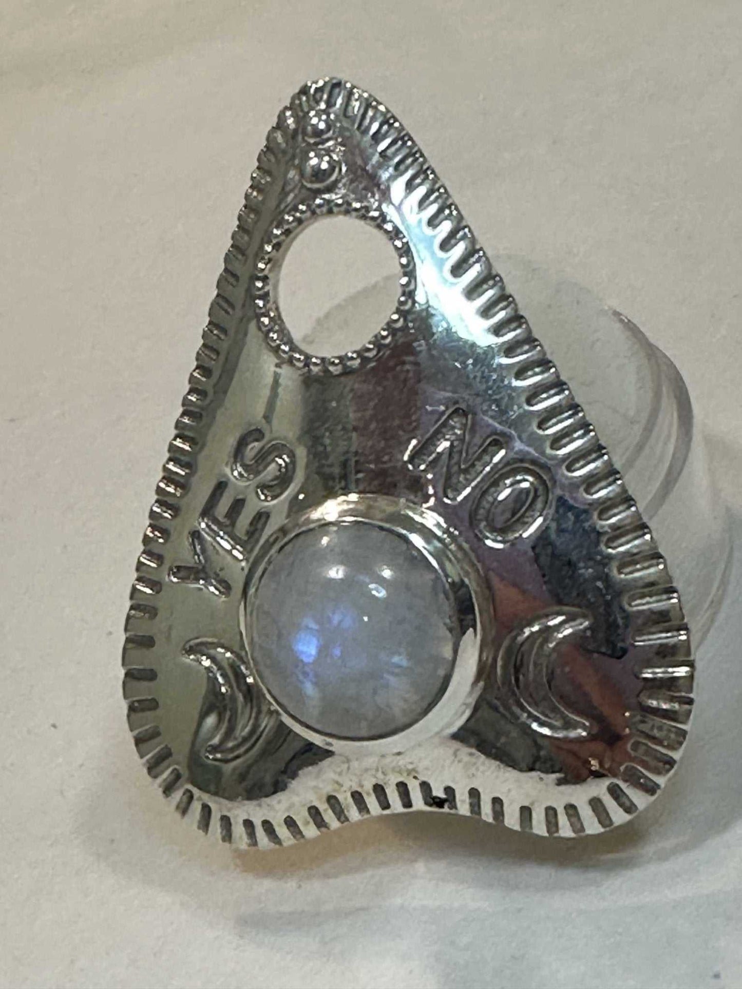 Planchette-shaped ring set with a rainbow moonstone cabochon, with an open viewing window at the tip