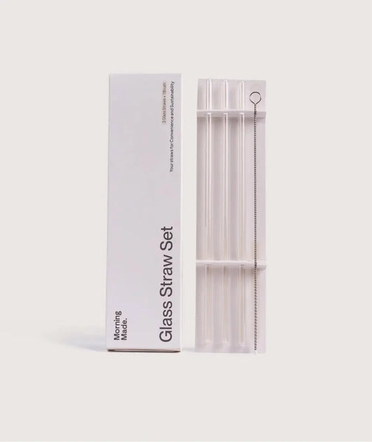 Set of three reusable glass straws with a cleaning brush