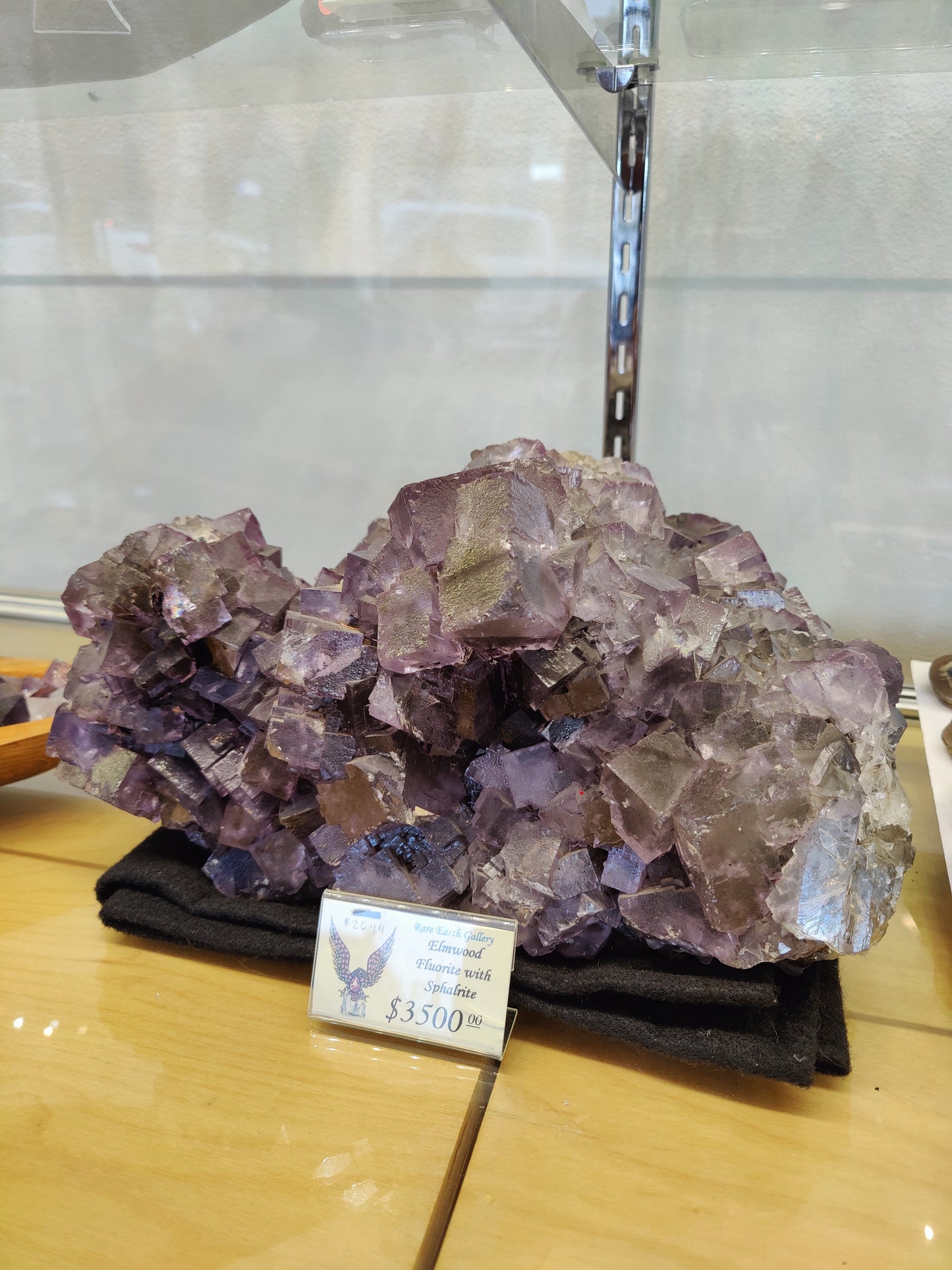 Cluster of sharp purple cubic fluorite crystals with dark sphalerite on natural matrix — view 2