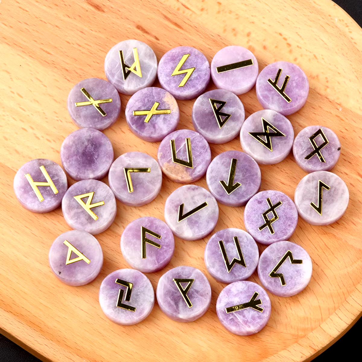 Set of round polished crystal runes engraved with runic symbols, scattered on a dark surface — view 8 of 12