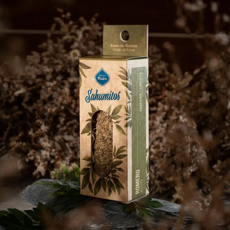 A boxed smudge stick standing upright against dried flowers