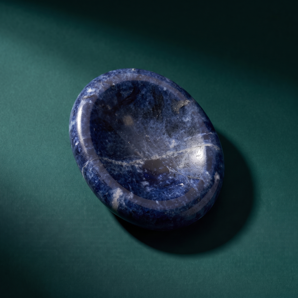 The same sodalite comfort stone from above, mottled blue and white across the polished surface