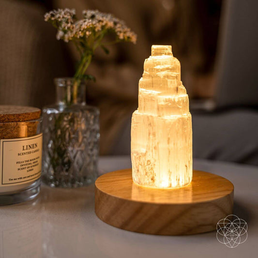 Natural selenite crystal lamp glowing with a soft warm light — view 1 of 7