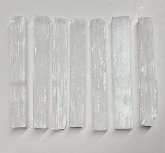 Three-inch pearly white selenite stick with fine vertical striations