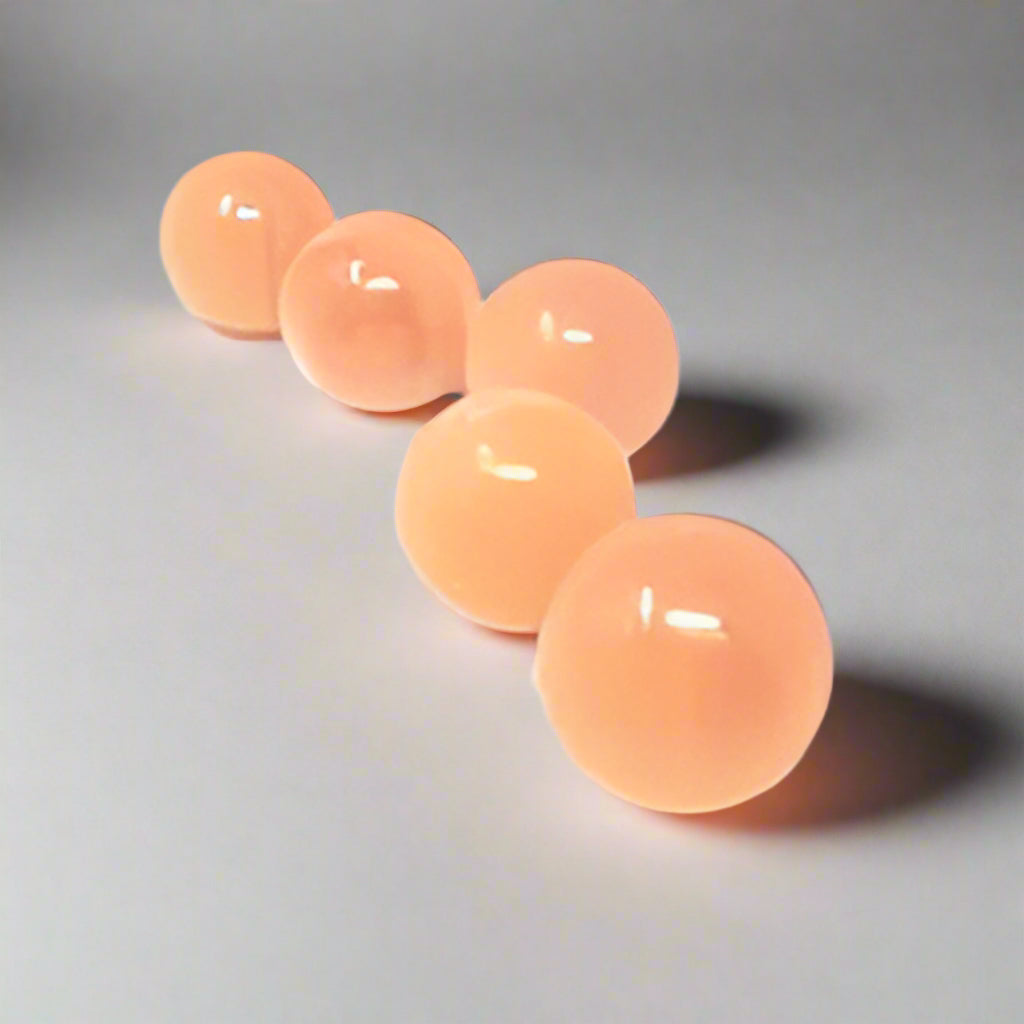 Peach selenite pocket sphere with a soft satin finish, alternate view