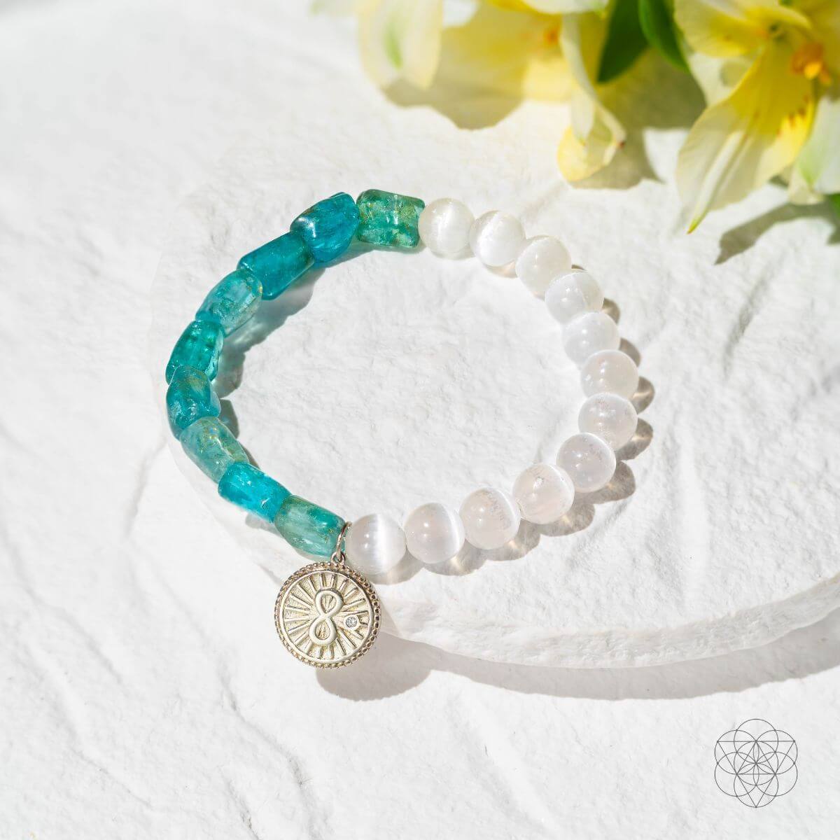 Bracelet with raw blue apatite and translucent selenite beads joined by a platinum-plated infinity charm — detail view 5