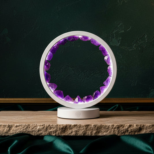 Amethyst ring lamp lit purple on a wooden plank against dark green velvet