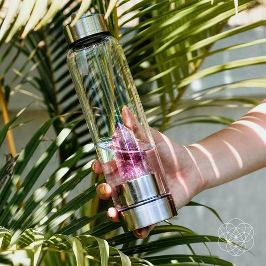 Glass water bottle with a natural amethyst crystal point set into the base — view 1 of 6