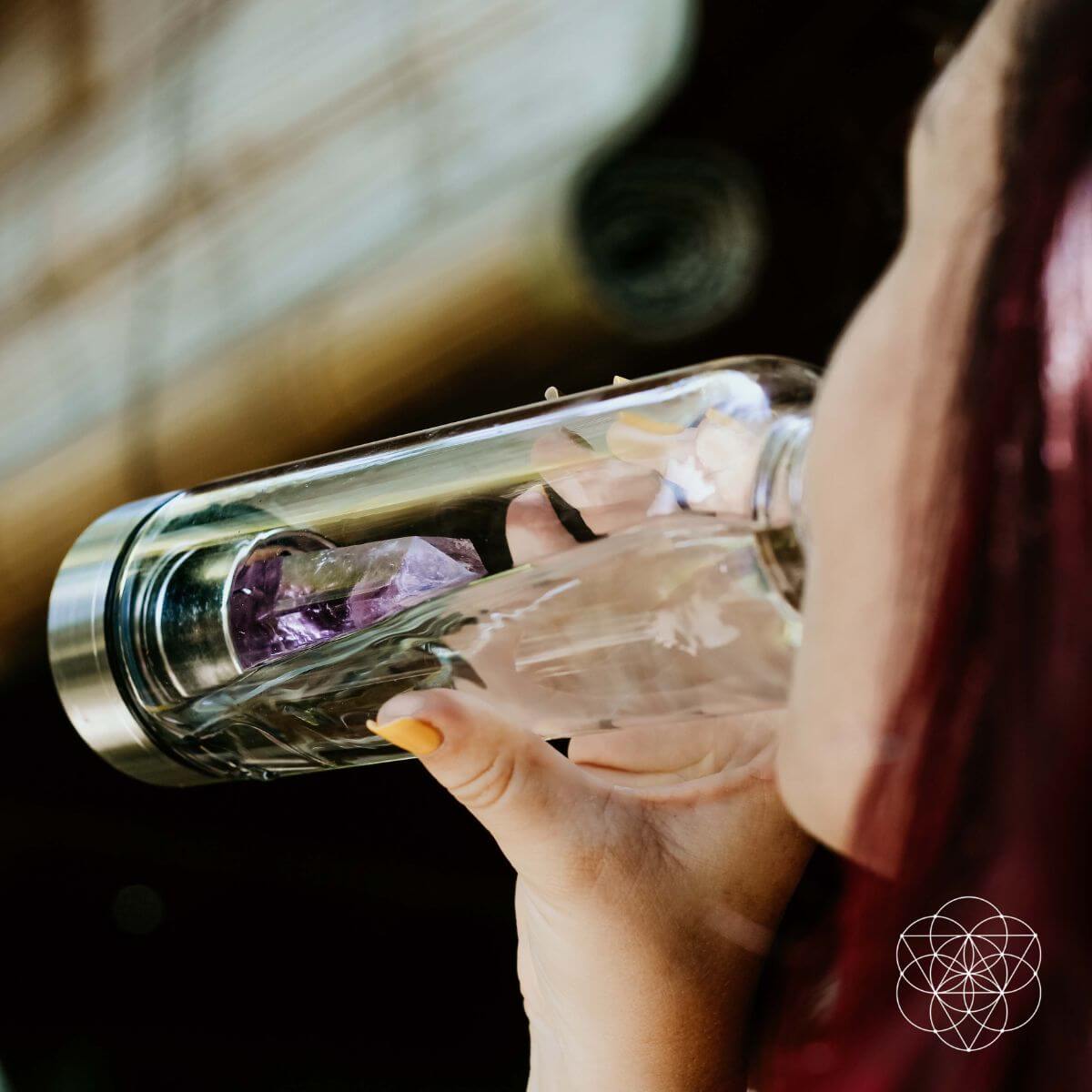Glass water bottle with a natural amethyst crystal point set into the base — view 2 of 6
