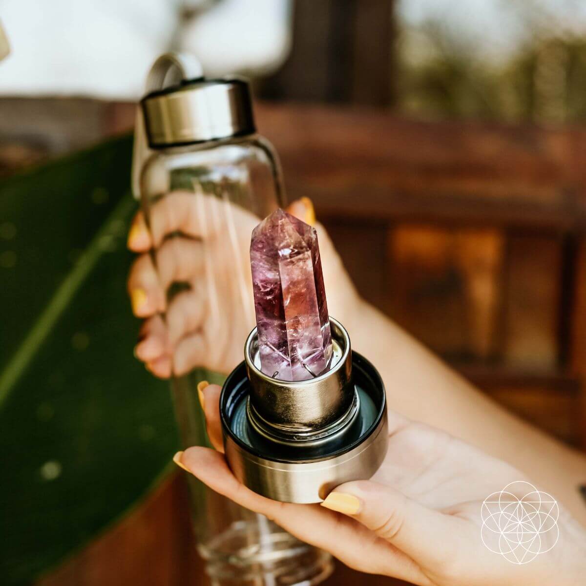 Glass water bottle with a natural amethyst crystal point set into the base — view 3 of 6