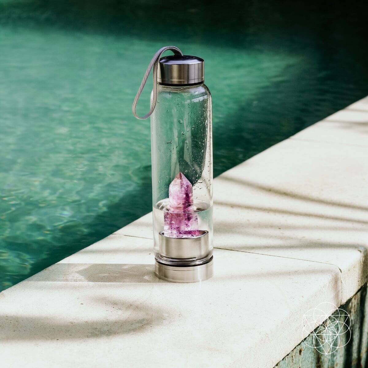 Glass water bottle with a natural amethyst crystal point set into the base — view 5 of 6