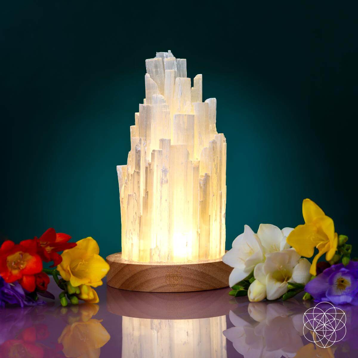 Tall Selenite crystal lamp glowing on a walnut base