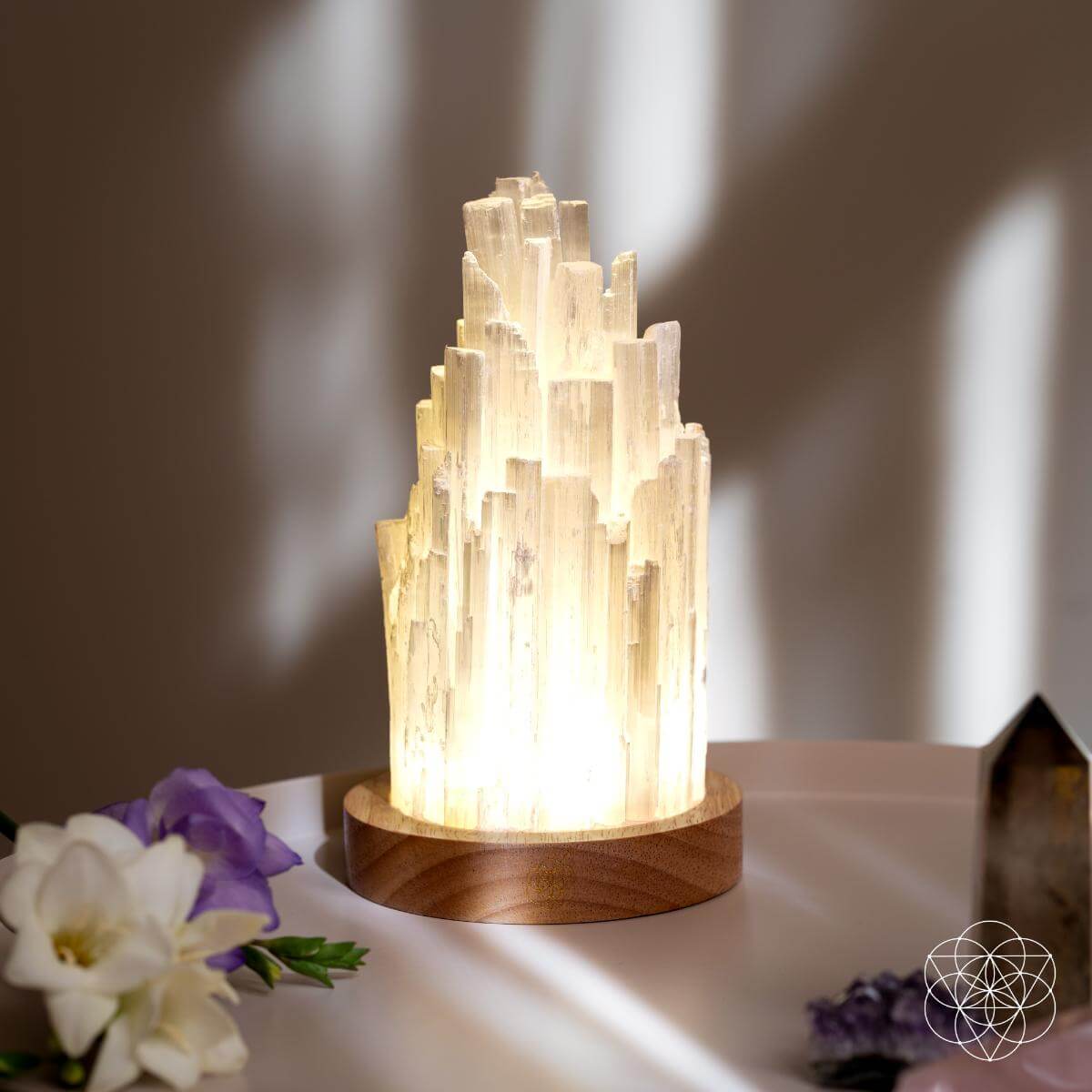 Tall Selenite crystal lamp glowing on a walnut base — view 6