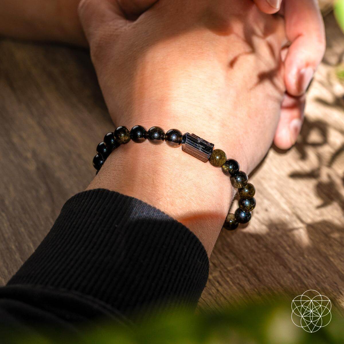Bracelet of black tourmaline beads and golden obsidian beads with a warm sheen — detail view 3