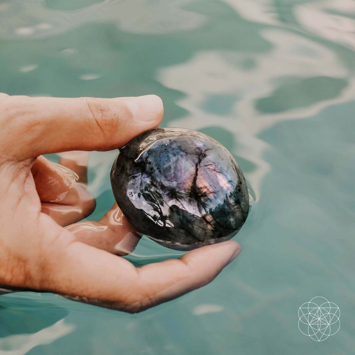 Raw labradorite stone shimmering with green and blue flashes — view 3 of 6