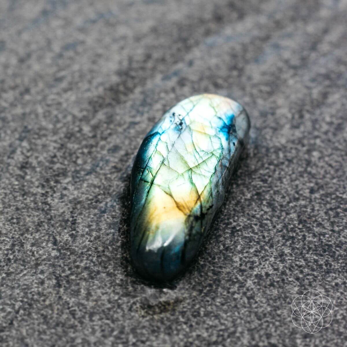 Raw labradorite stone shimmering with green and blue flashes — view 4 of 6
