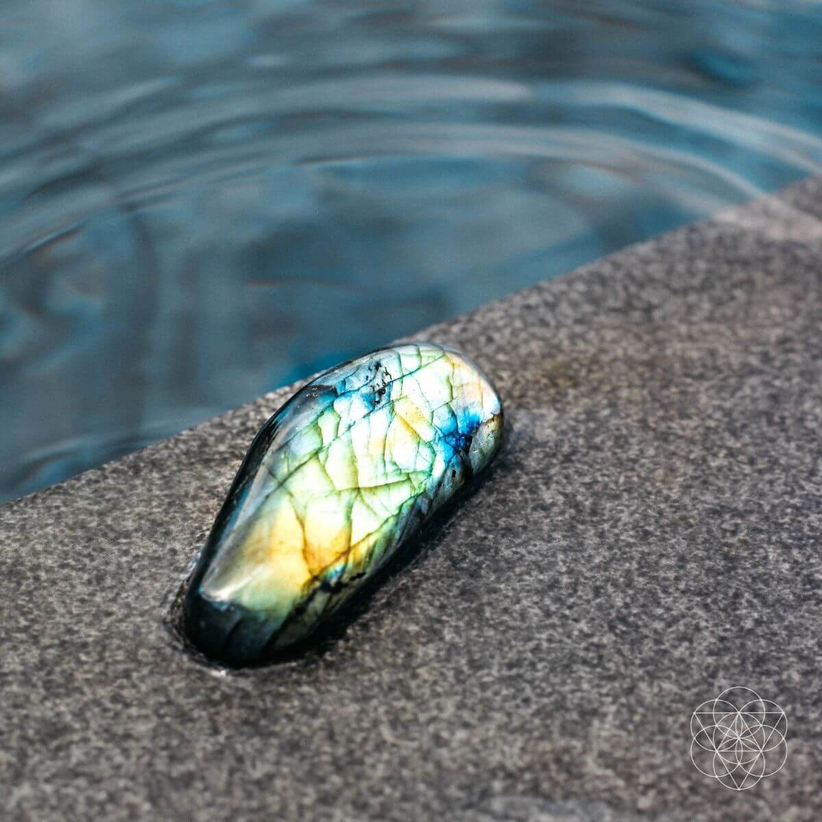 Raw labradorite stone shimmering with green and blue flashes — view 1 of 6