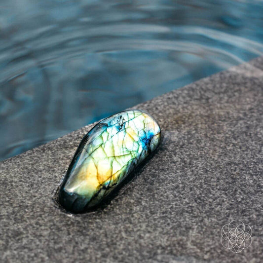 Raw labradorite stone shimmering with green and blue flashes — view 1 of 6
