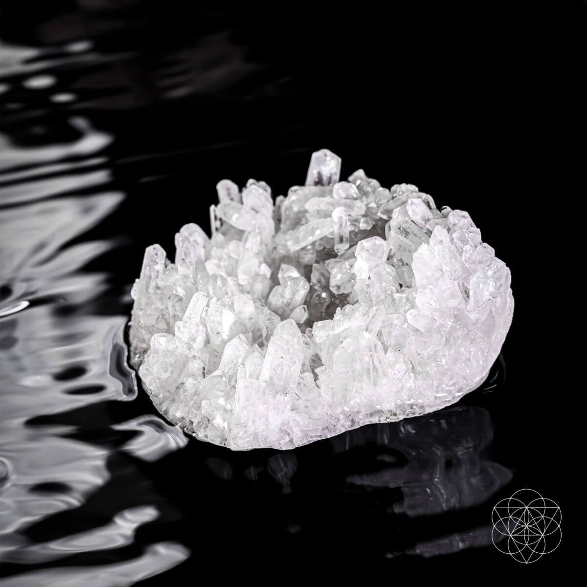 Clear quartz crystal lamp glowing softly on a wooden base — detail view 6