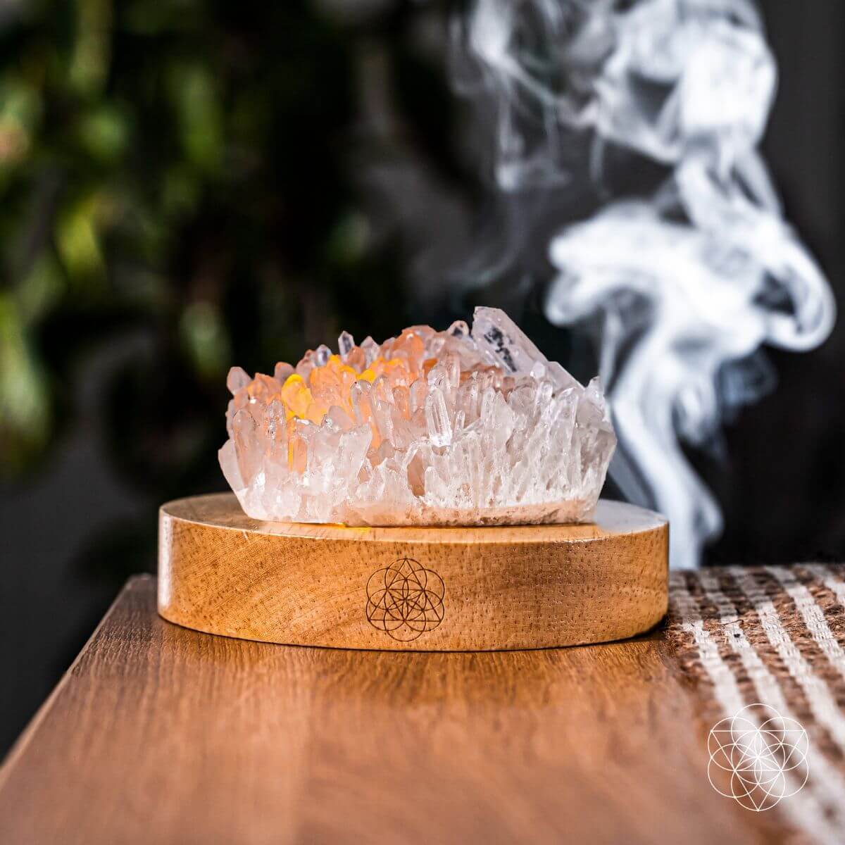 Clear quartz crystal lamp glowing softly on a wooden base — detail view 4