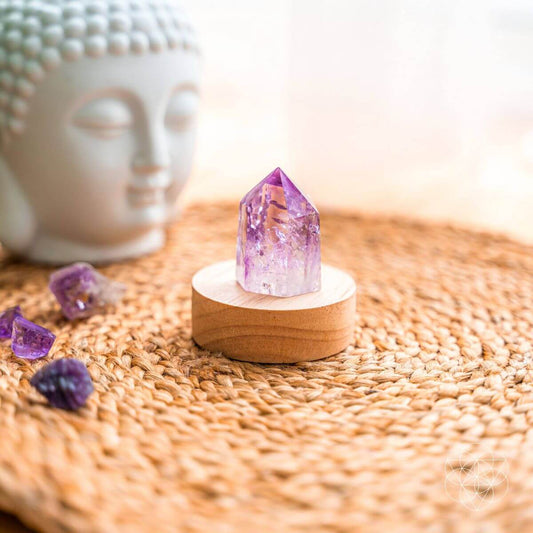Amethyst crystal point lamp on a bedside table with soft purple light — view 1 of 7