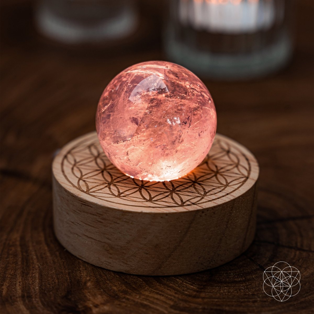 Amethyst crystal ball lamp on a Seed of Life patterned base, glowing warm pink — view 1 of 7