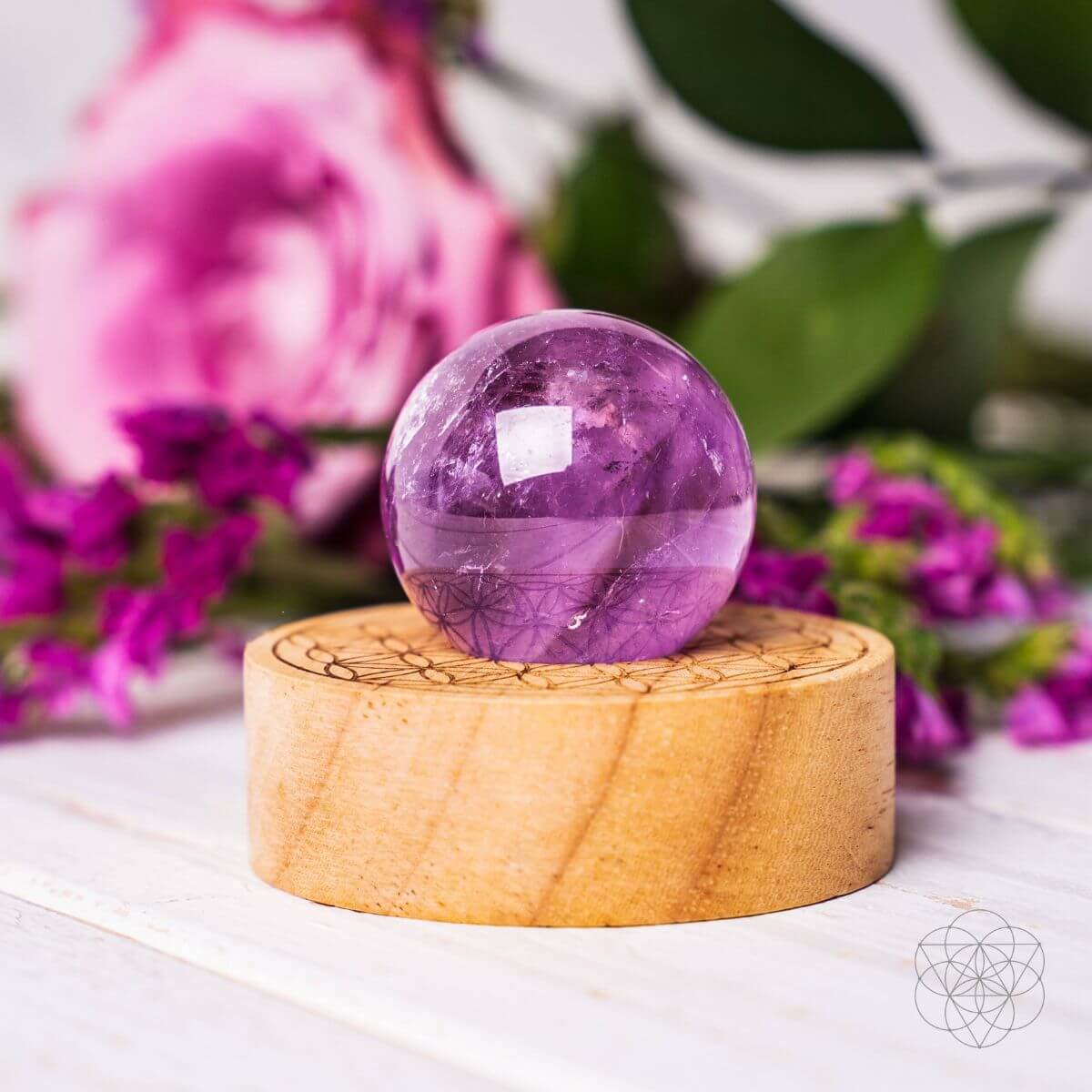 Amethyst crystal ball lamp on a Seed of Life patterned base, glowing warm pink — view 3 of 7