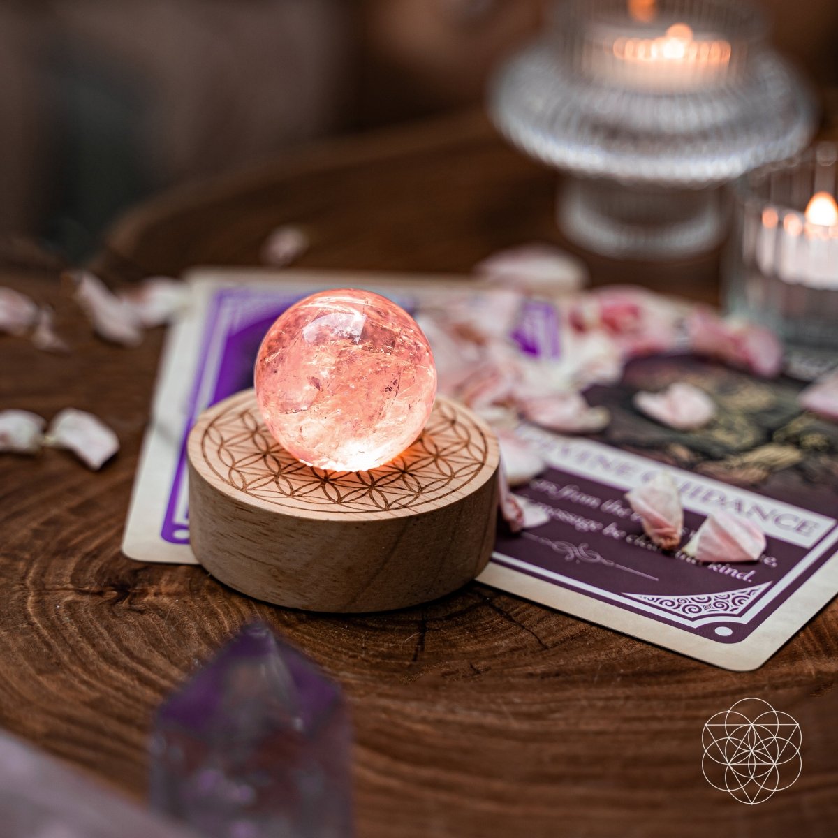 Amethyst crystal ball lamp on a Seed of Life patterned base, glowing warm pink — view 5 of 7