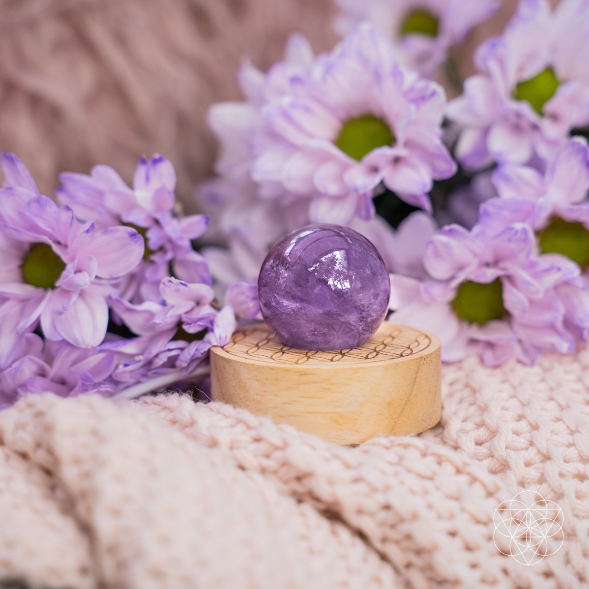 Amethyst crystal ball lamp on a Seed of Life patterned base, glowing warm pink — view 2 of 7