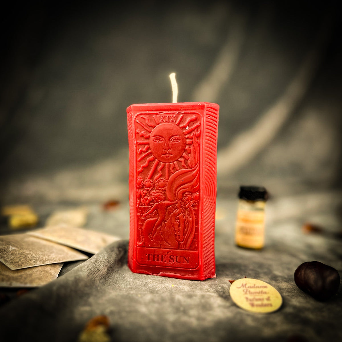 The Sun beeswax tarot candle in red with the kit oil bottle