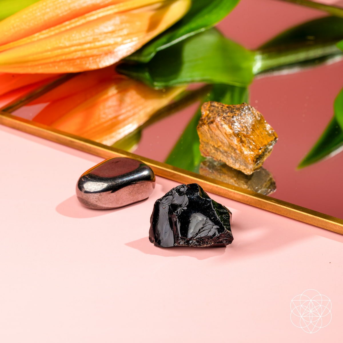 Three raw protection stones — black Obsidian, golden Tiger's Eye, and silver Hematite — view 4