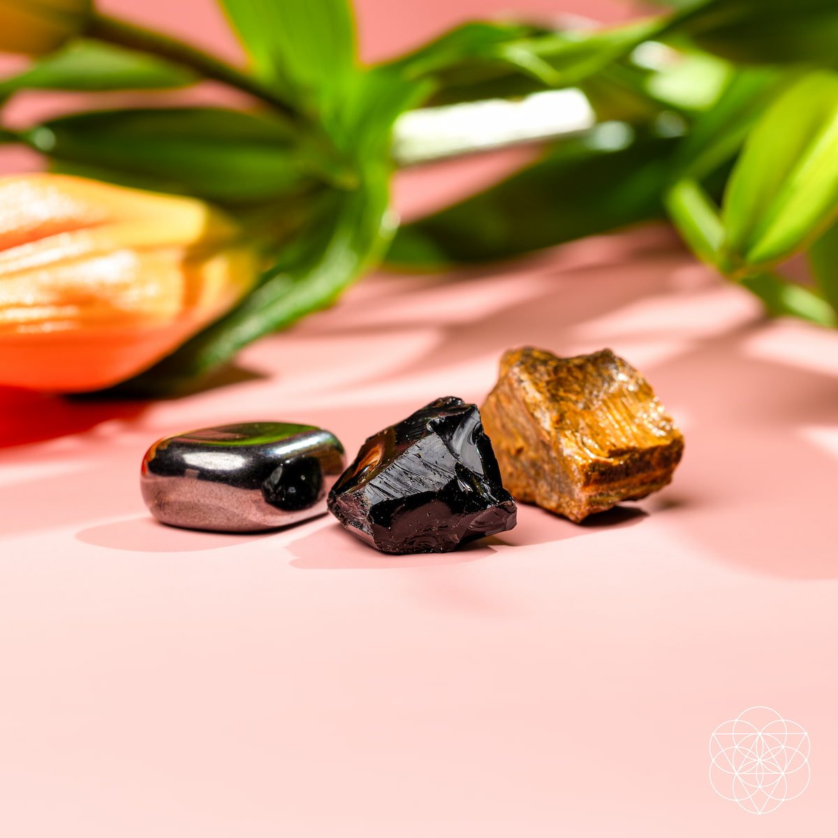 Three raw protection stones — black Obsidian, golden Tiger's Eye, and silver Hematite — view 3