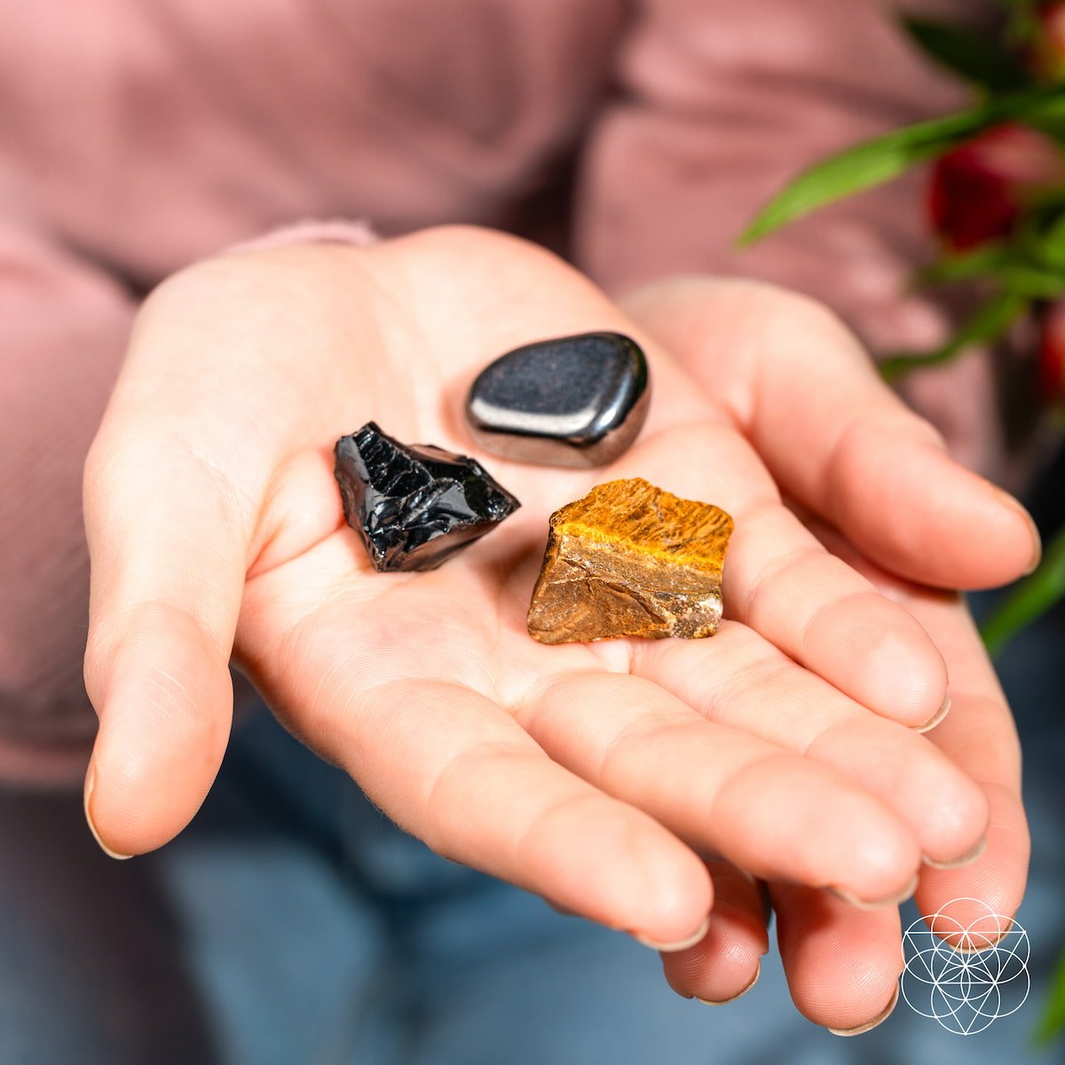 Three raw protection stones — black Obsidian, golden Tiger's Eye, and silver Hematite — view 2